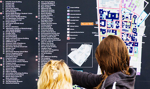 Students reading from campus map