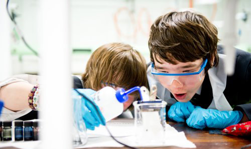 Two primary school children having fun with an experiment