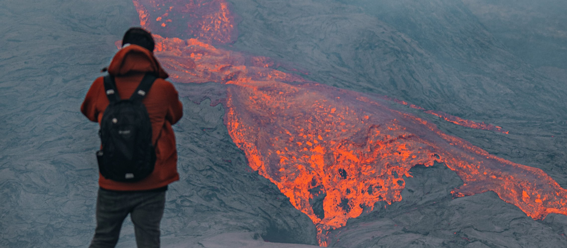 Student observing molten lave flows.