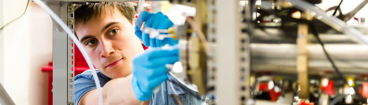 A researcher adjusting intricate machinery