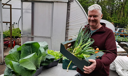 Dave Hanlon with box of fresh vegetables grown at the Firs