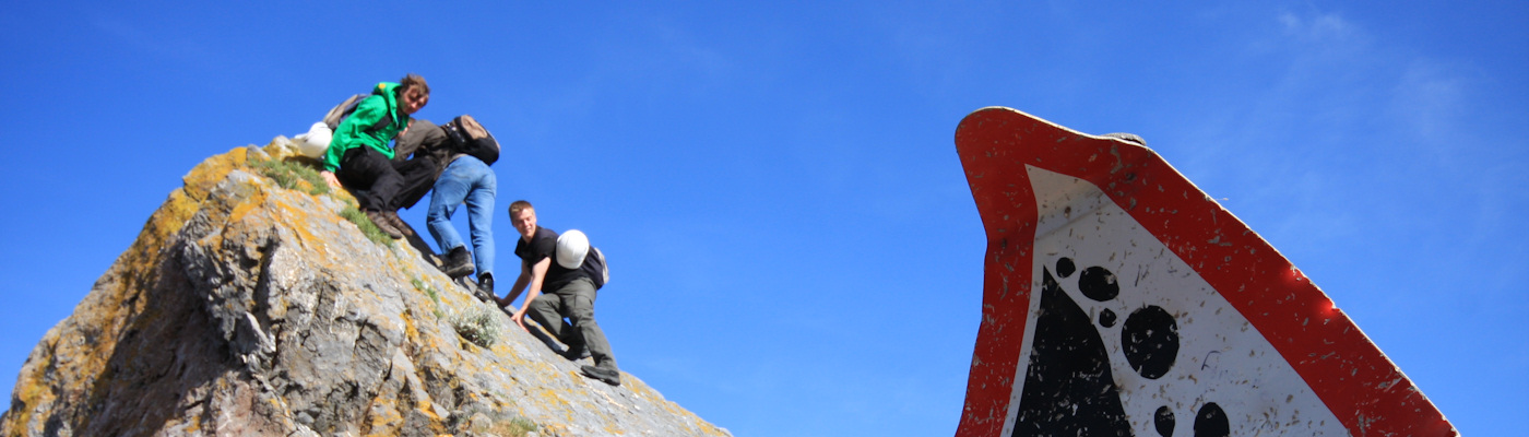 Students on field trip climbing a rock