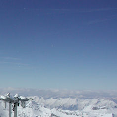 Snowy mountain tops against a clear sky
