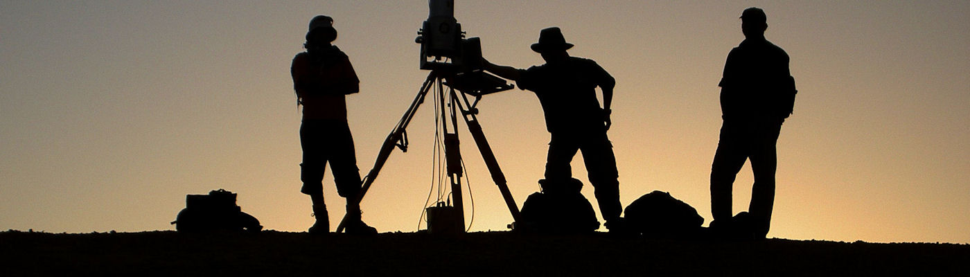 researchers silhouetted against a sunset