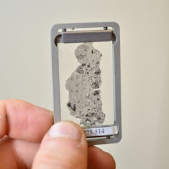 Microscopic sample being held up to the light