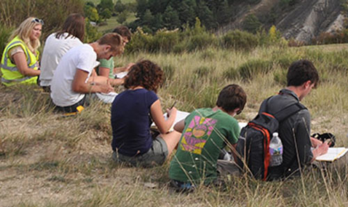 A group of students on a field trip by the sea