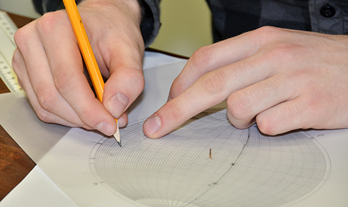 Hands sketching an intimate diagram with a pencil