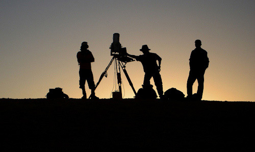 Researchers silhouetted against sunset