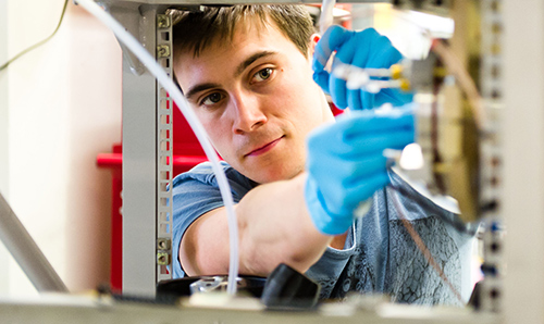 A researcher adjusting intricate machinery