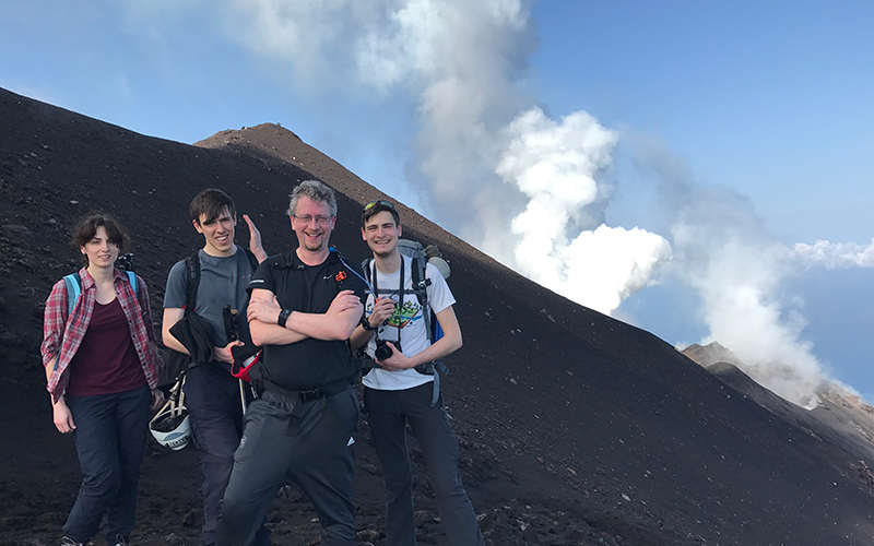 Students posing on a volcano