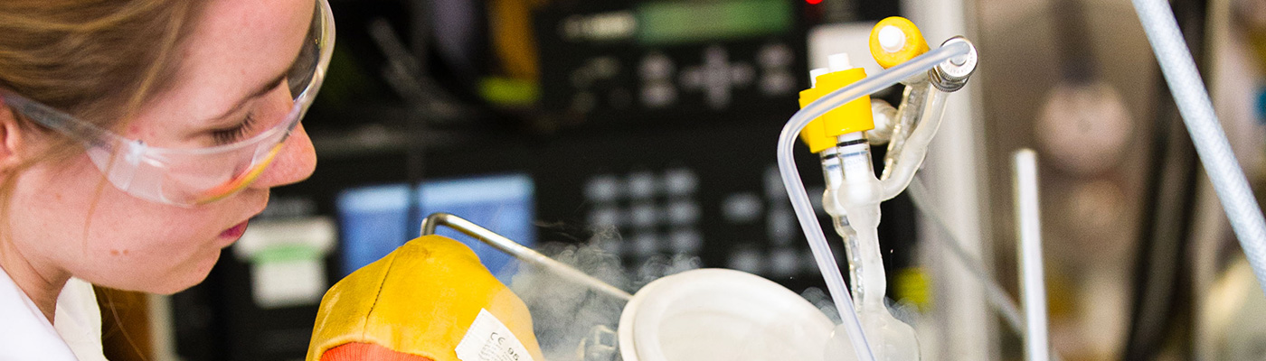 A female researcher pouring out a steam-filled container