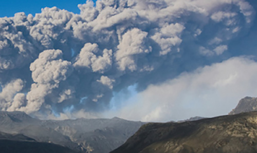 Smoke emerging above a mountain top